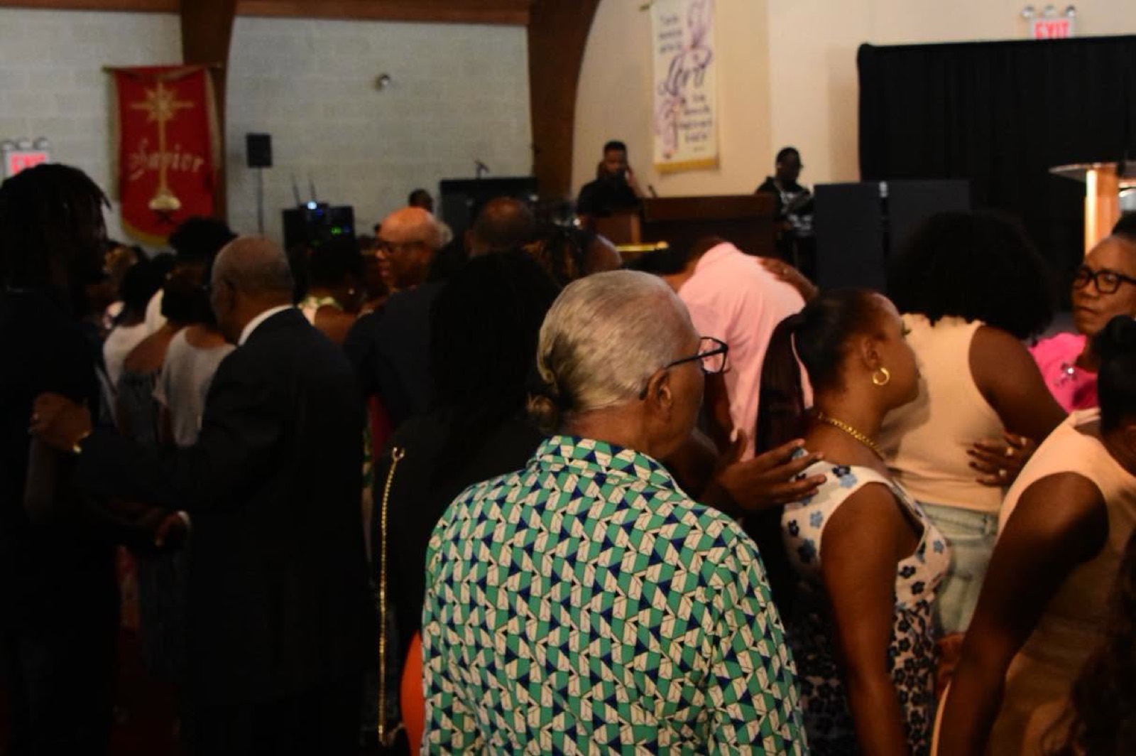 Members greet one another in the sanctuary after service.