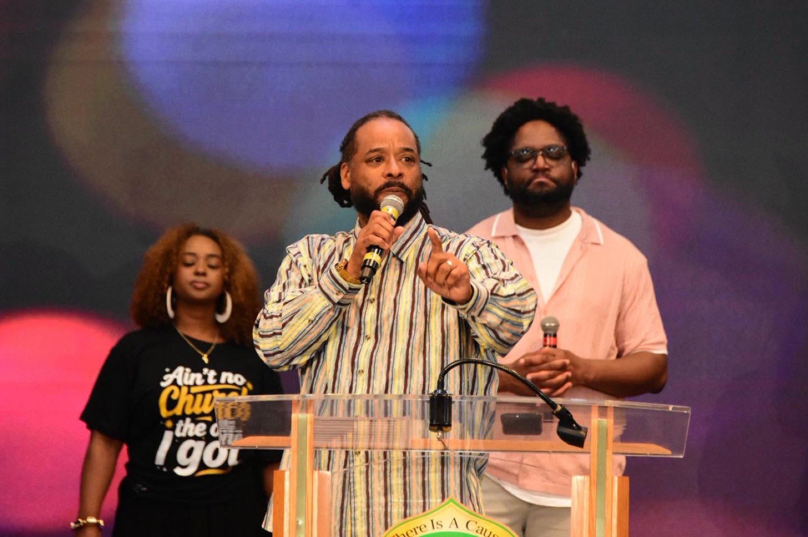 Three worship leaders minister together at the pulpit.